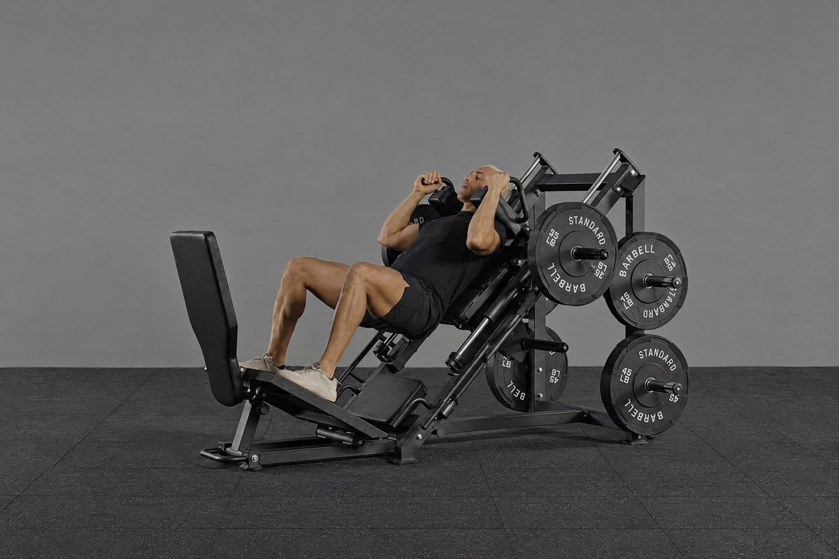 Man performing hack squats on GMWD LH01 combo leg training machine in home gym.